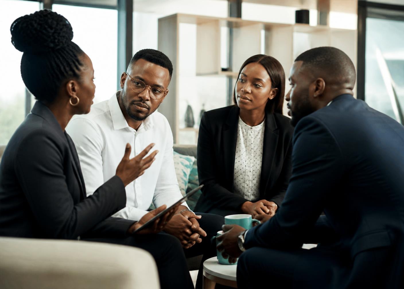 Black African business leaders in a focused working session